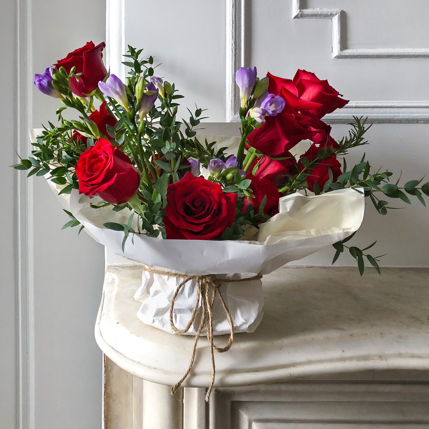 red roses with purple flowers and textured greens 